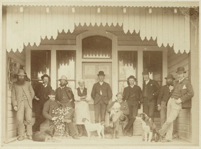 Group of men and dogs on a veranda