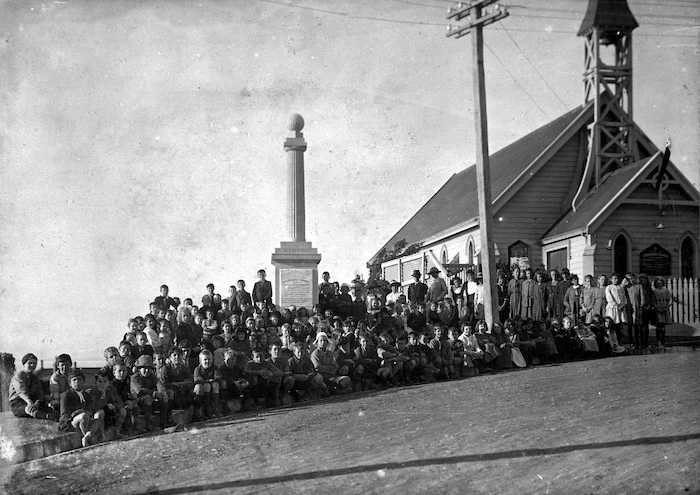 Pupils of Roseneath School, Wellington, alongside a World War I memorial