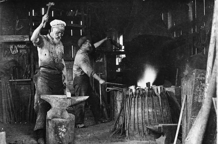 Men working in a blacksmithing shop