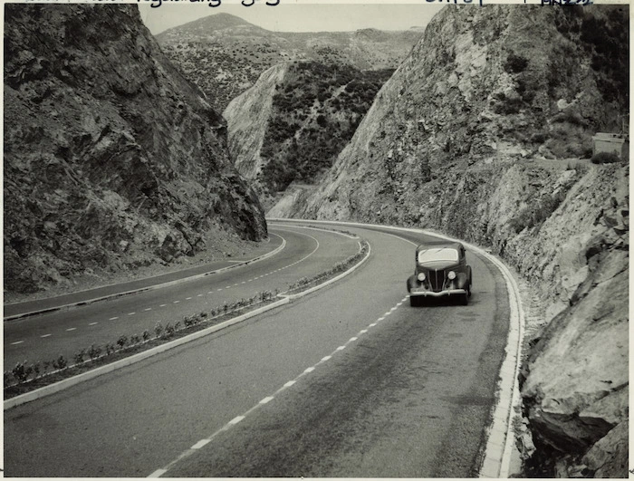 Car travelling up Ngauranga Gorge, Wellington - Photograph by John Dobree Pascoe