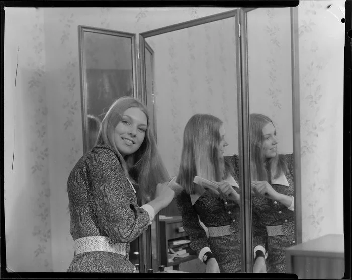 Woman looking in mirror