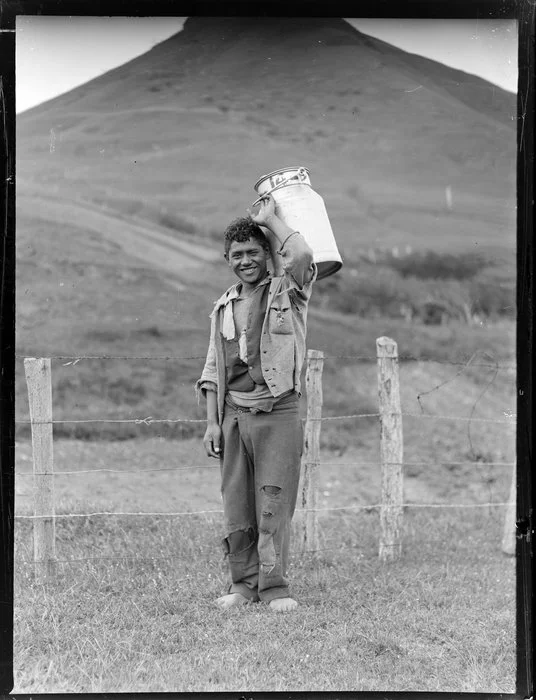 Māori boy carrying a milk container, Waiotaka