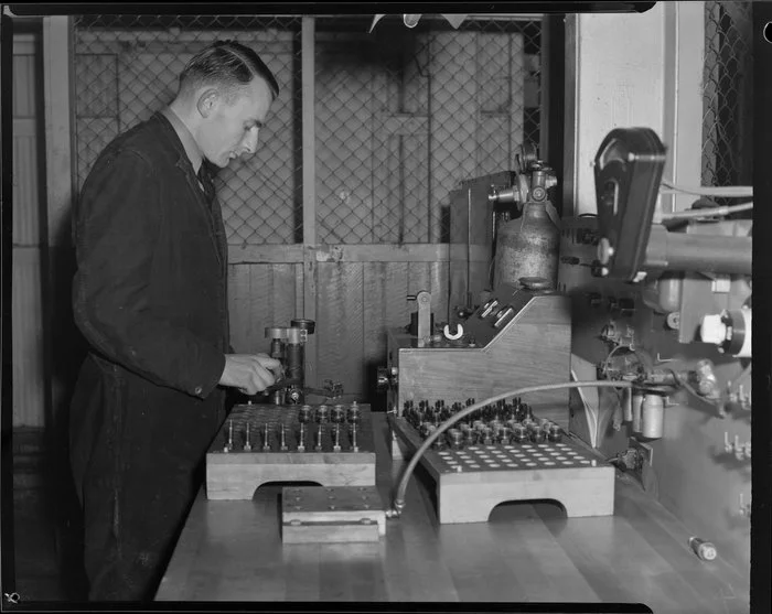 Leading Aircraftman, E Hart at spark plug test bench, Wigram, Christchurch