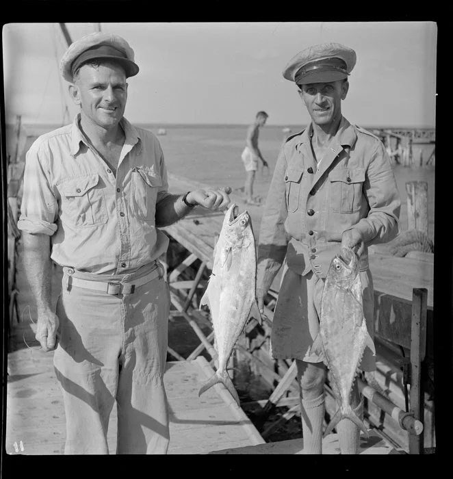 Two men with catch of fish, Darwin wharf, Australia