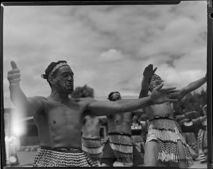 Maori men performing Haka at the welcoming ceremony of Sir Peter Buck, Ngāruawāhia, Waikato