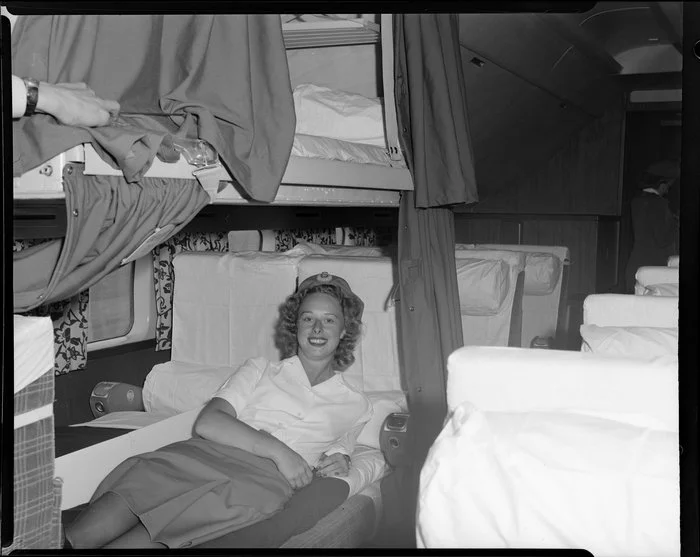 Air hostess Miss D Kelpie demonstrating the sleeper in the DC6 aeroplane RMA Discovery