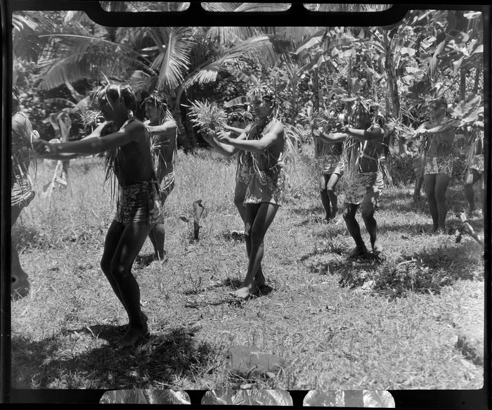 Young local boys perform a dance at a ceremony feast, Tahiti