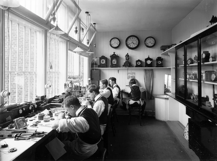 Five men working in a clock and watch making workshop