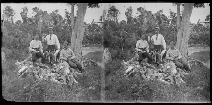 Three unidentified hunters, with dead rabbits in front of them, Catlins, Otago