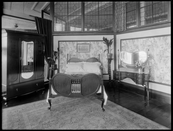 Double bedroom suite scene, with dresser with mirror, wardrobe with mirror and plants on plant stands