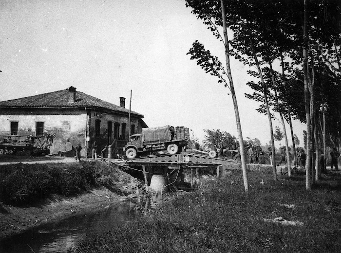 Truck and soldiers of 2nd NZEF, 25 Battalion, B Company, crossing the Scissors bridge, before San Giorgio, Italy