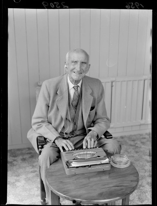 Mr G R Sykes, typing on his Empire typewriter