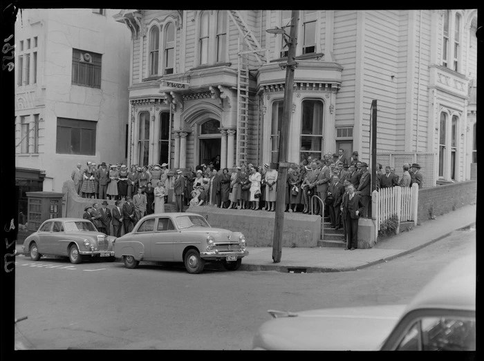 Unidentified collectors for the Young Women's Christian Association outside a two-storied colonial villa, Wellington