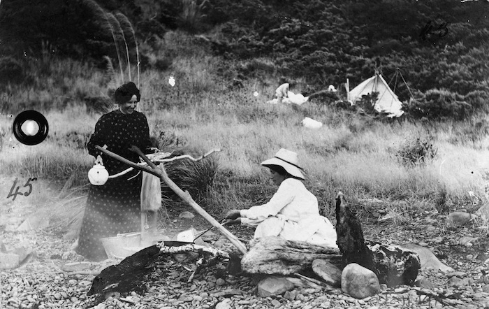 Women from the Whiting and Vaughan party cooking on a camp fire, at Kapiti Island