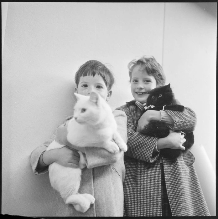 Two unidentified children holding cats at the Wellington cat club's show