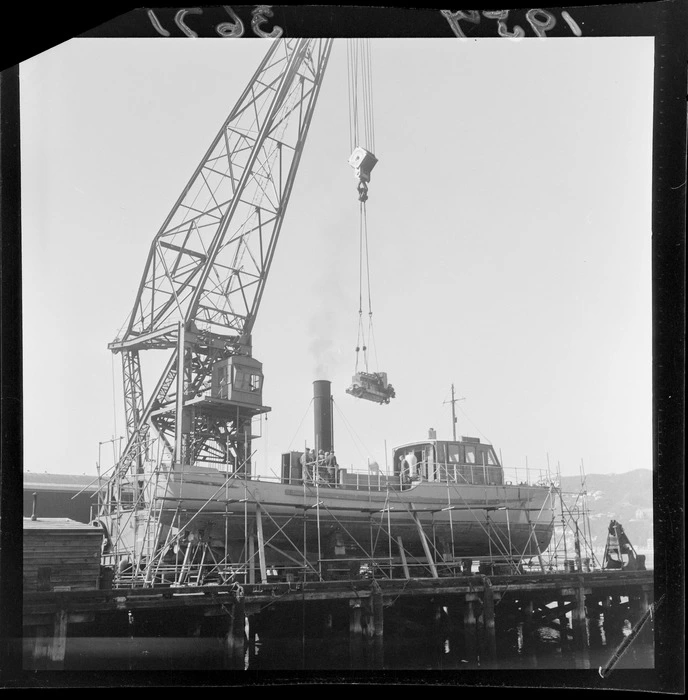 Floating crane, Hikita, lifting an engine into pilot launch, Tiakina