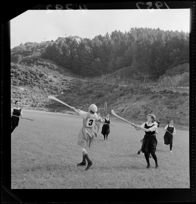 Irish women playing a camogie game at an unidentified sportsground, Wellington