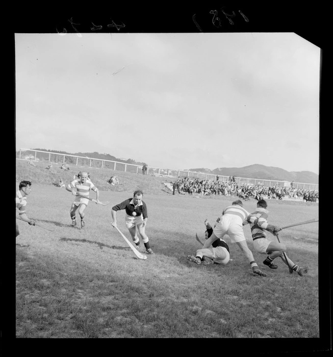 Irish men in a hurling match, at an unidentified sportsground, Wellington