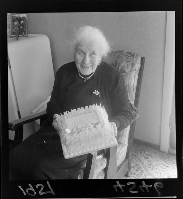 Mrs Dumbleton holding a birthday cake