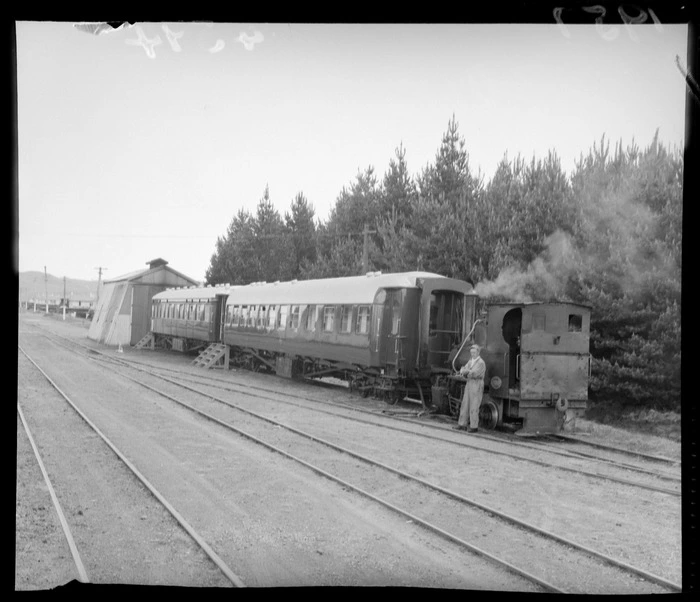 The train used by the Governor General at Waiouru, Taihape, including driver standing next to shunting locomotive steam engine