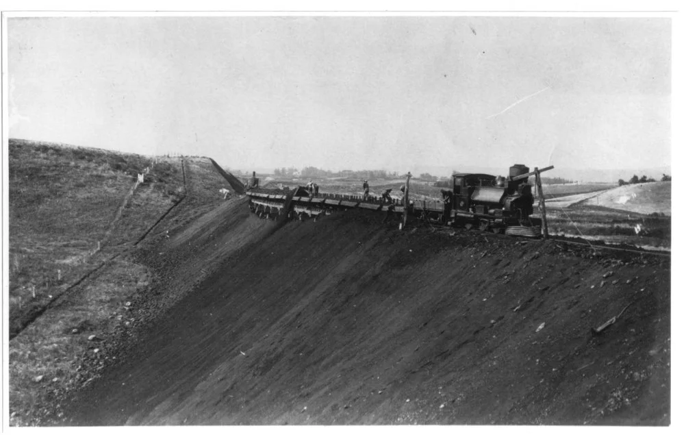 Muck train carrying fill from cutting at Karaka Bank Pukekohe and dumping it. F Class Locomotive