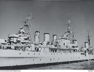 PORT MELBOURNE, VIC. 1951-10-10. DETAIL VIEW OF THE CRUISER HMNZS BELLONA ALONGSIDE THE CRUISER HMAS AUSTRALIA. NOTE THE DUAL AERIALS OF THE TYPE 281 AIR SEARCH RADAR ON THE BELLONA'S MASTHEADS. ..