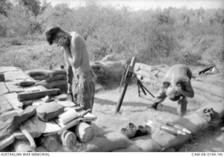 BIEN HOA PROVINCE, SOUTH VIETNAM. 1968-02. BLOCKING THEIR EARS IN THEIR GUN PIT, AS THEY REGISTER A DEFENSIVE FIRE TASK DURING OPERATION COBURG ARE MORTARMEN WITH 2RAR /NZ (ANZAC) (THE ANZAC ..