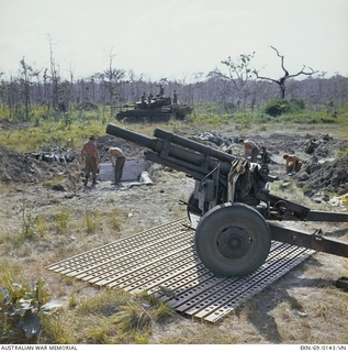 May Tao, South Vietnam. 2 December 1969. A 105mm howitzer gun of 101st Battery, Royal Australian Artillery, stands ready for instant action on steel mesh matting in support of 6RAR /NZ (ANZAC) (The ..