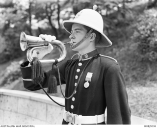 Yokohama, Japan. 25 April 1954. Musician/Bugler Trev Blatch of New Farm, Qld, blows the Last Post during an Anzac Day Ceremony in the Australian/New Zealand Section of the British Commonwealth War ..