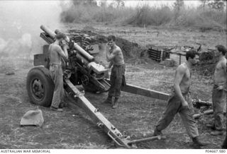 The gun crew of a 105mm M2A2 Howitzer of 101 Field Battery Royal Australian Artillery (RAA) prepares to re-load the gun at Fire Support Base (FSB) Baton, an FSB of the Army of the Republic of ..