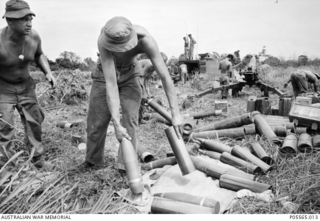 Gunners from 161 Battery, Royal New Zealand Artillery (RNZA), preparing ammunition for an artillery barrage against suspected Viet Cong positions during Operation Ingham. The gunner (foreground) is ..