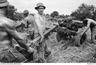 Members of 161 Battery, Royal New Zealand Artillery (RNZA), manhandling their Italian manufactured OTO Melara L5 105 mm Pack Howitzer onto a flatter firing position during Operation Ingham. ..