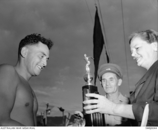 At the British Commonwealth Forces, Korea (BCFK), annual Swimming Meet held last Saturday, the individual champion was Bombardier (Bdr) W 'Mac' McGregor (left), of Hawkes Bay, New Zealand. Here Mrs ..