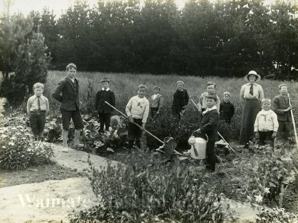 Tawai School pupils and teacher in their garden plots, 1914.