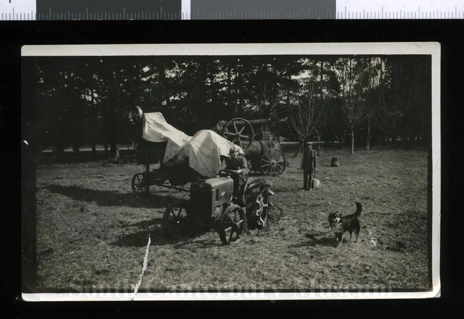 Alex McCaw driving a Austin tractor hitched to a chaff cutter