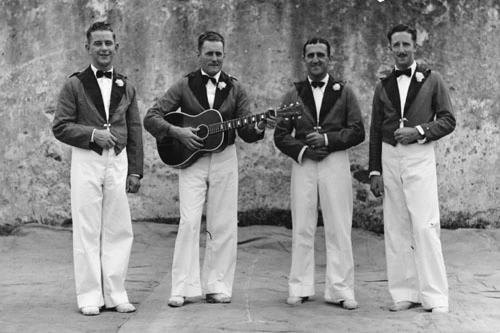 Oswald Cheesman (with guitar) and band members
