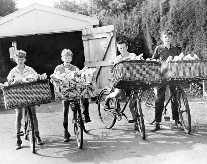 Newspaper delivery boys on bikes