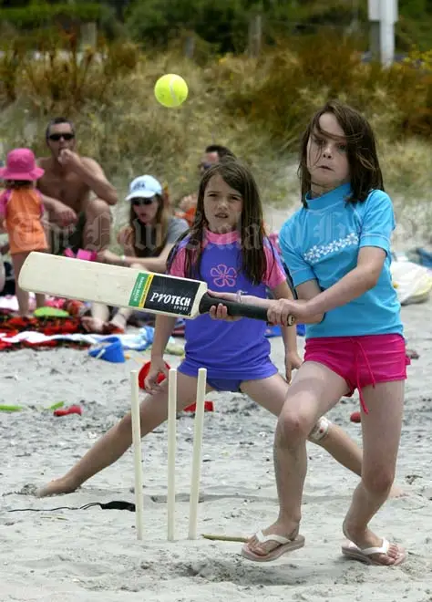 Children playing beach cricket