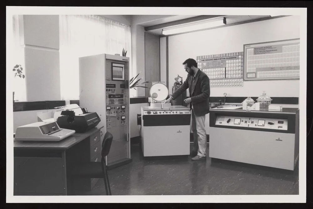 Man in a lab loading samples into the Siemens spectrometer