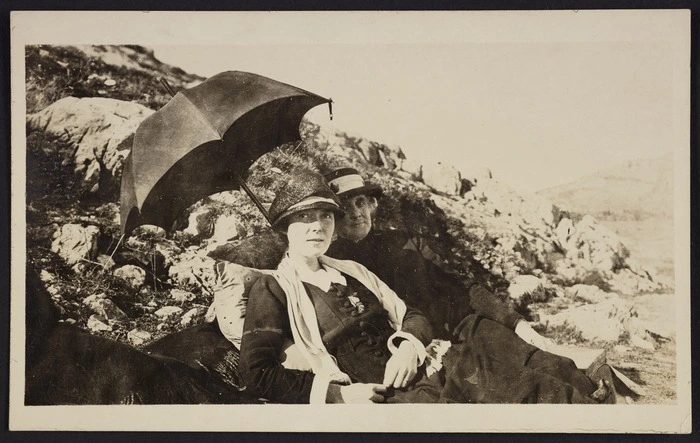 Katherine Mansfield reclining beside rocks